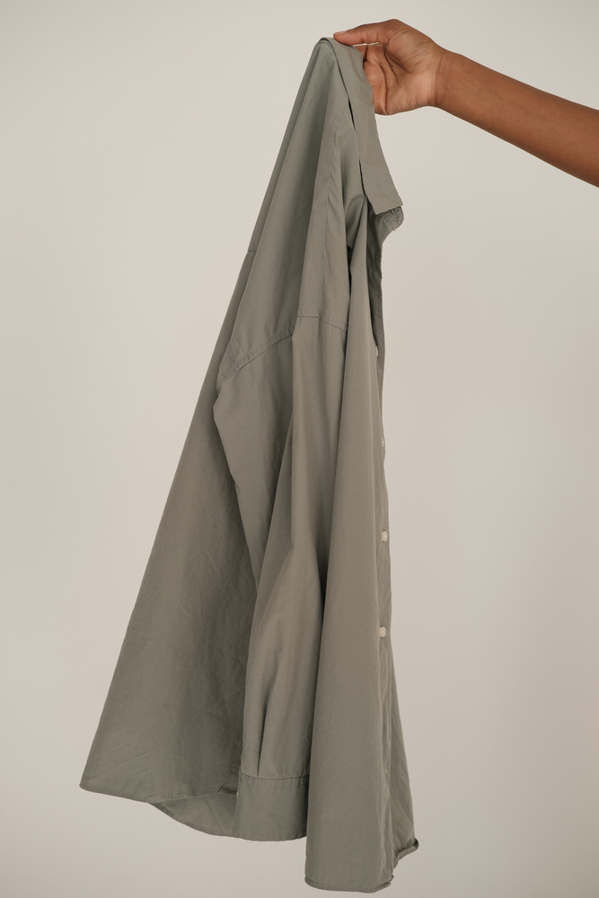 Hand Holding Light Grey Dress Shirt